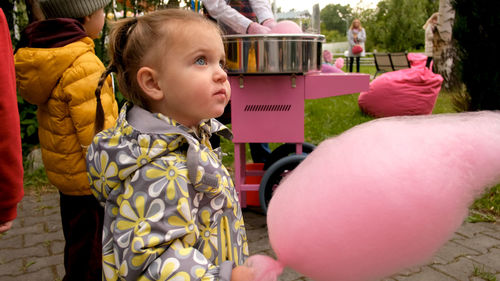 Girl eating candy floss in park