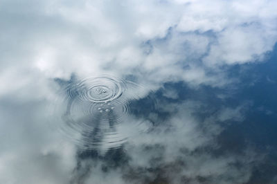 Digital composite image of spiral against sky