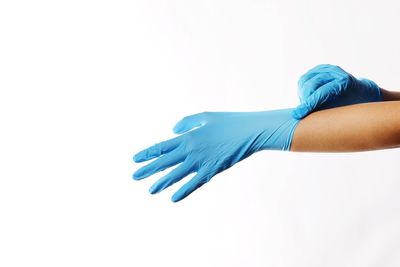 Close-up of hands over white background