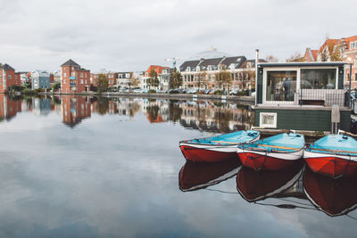 Boats moored on sea against sky