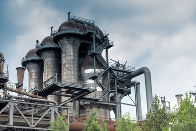 Low angle view of factory against sky