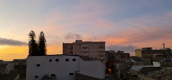 High angle view of buildings against sky during sunset