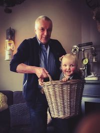 Portrait of father and son sitting at home