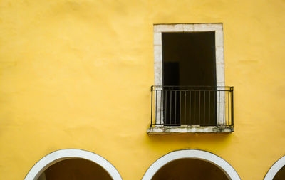 Low angle view of yellow window on building