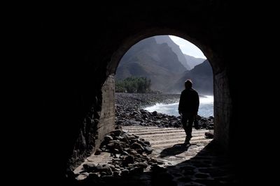 Rear view of silhouette man standing in corridor