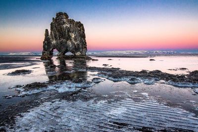 Hvitserkur at beach against clear sky during sunset