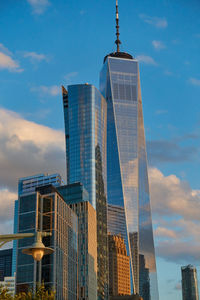 Low angle view of modern building against cloudy sky