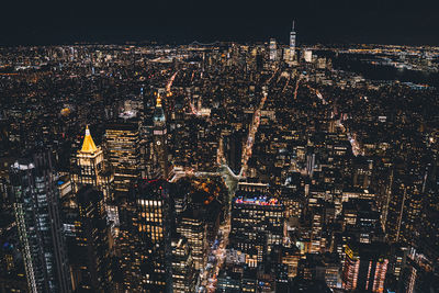 Aerial view of city lit up at night