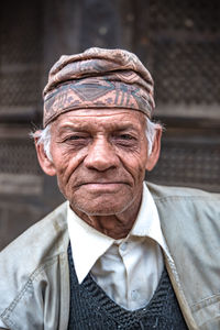 Portrait of senior man sitting outdoors