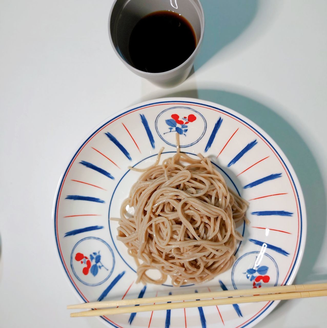 food and drink, food, pasta, drink, italian food, plate, indoors, cup, mug, crockery, meal, healthy eating, directly above, freshness, no people, table, refreshment, coffee, still life, spaghetti, tableware, wellbeing, coffee cup, high angle view, kitchen utensil