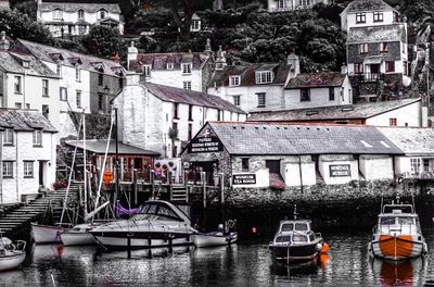 Boats in river with buildings in background