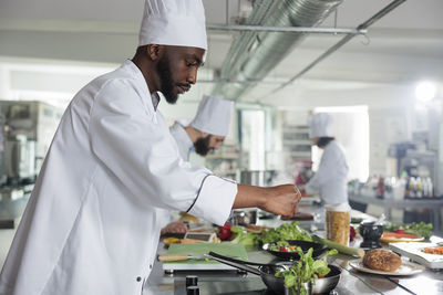 Midsection of man preparing food at home