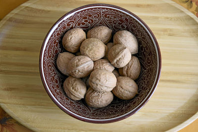 High angle view of walnuts in bowl on table