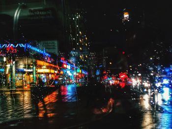 Illuminated city street at night