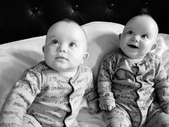 High angle view of twin baby boys relaxing on bed at home