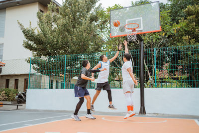 Low section of people playing basketball