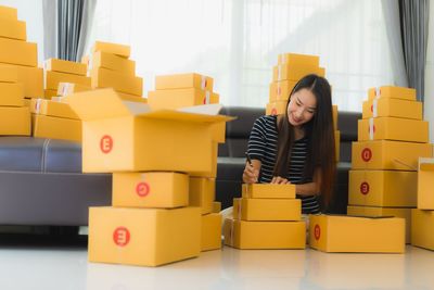 Full length of a smiling young woman sitting at toy