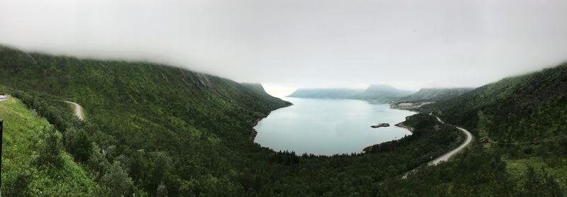 Scenic view of sea and mountains against sky