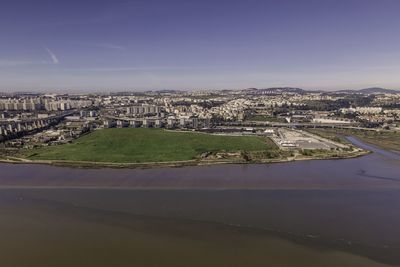 High angle view of river amidst buildings against sky