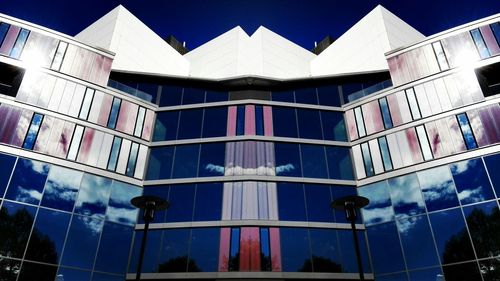 Low angle view of modern building against clear blue sky