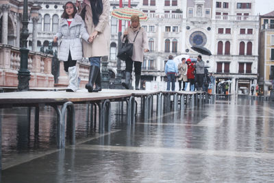 People walking in wet city