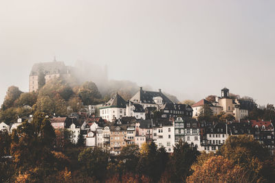 Houses in town against clear sky