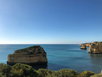 Scenic view of sea against clear blue sky