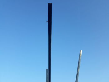 Low angle view of street light against clear blue sky