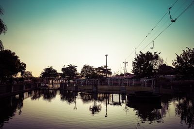 Scenic view of river against sky at sunset
