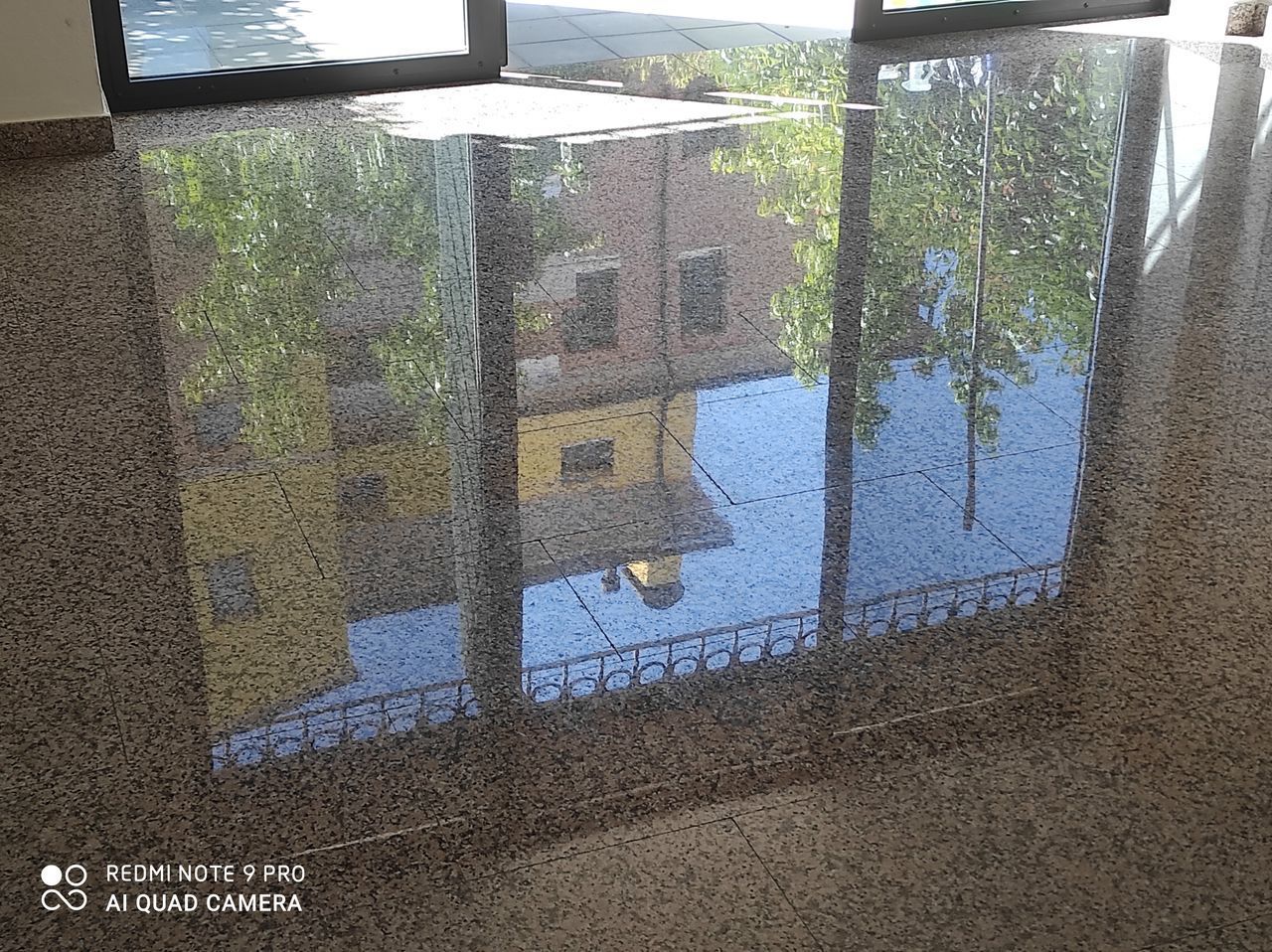 REFLECTION OF BUILDING IN GLASS WINDOW