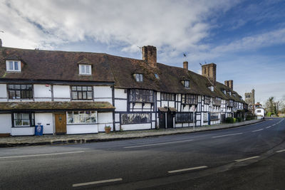 Biddenden high street showing timber framed houses and all saints church in the background
