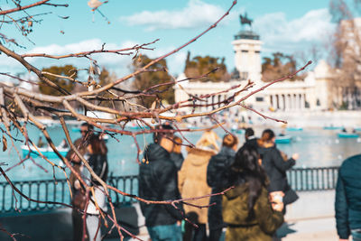 People standing in city against sky