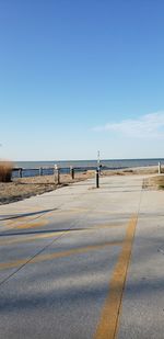 Scenic view of beach against clear blue sky