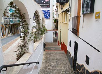 Footpath amidst buildings in city