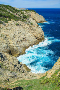 High angle view of rocks by sea