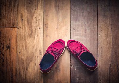 Directly above shot of shoes on wooden floor