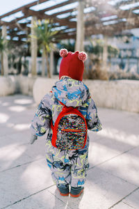 Rear view of woman standing on street