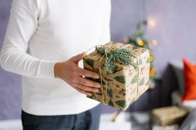 A man holds a christmas or new year gift in his hands. close-up of hands