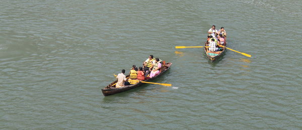 People traveling in boat at lake