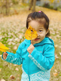 Portrait of  girl holding leaf