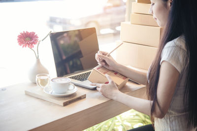 Woman using laptop on table