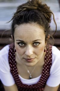 Portrait of smiling young woman sitting outdoors