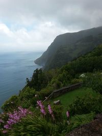 Scenic view of sea and mountains against sky