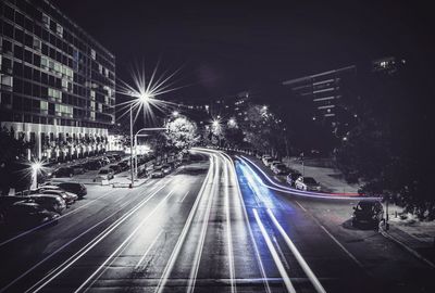 Light trails on road in city at night