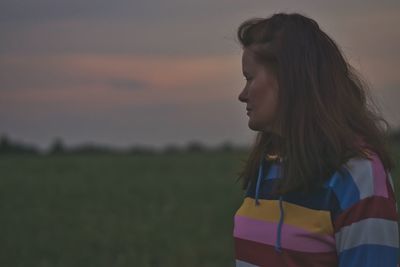 Portrait of a beautiful young woman standing on land