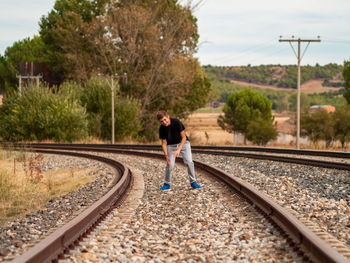 Woman standing on railroad track