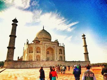 Tourists against blue sky