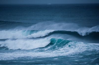 Scenic view of powerful rolling wave in sea