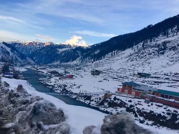 High angle view of snowcapped mountains against sky