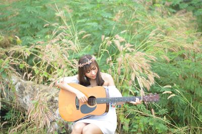 Young woman sitting on field